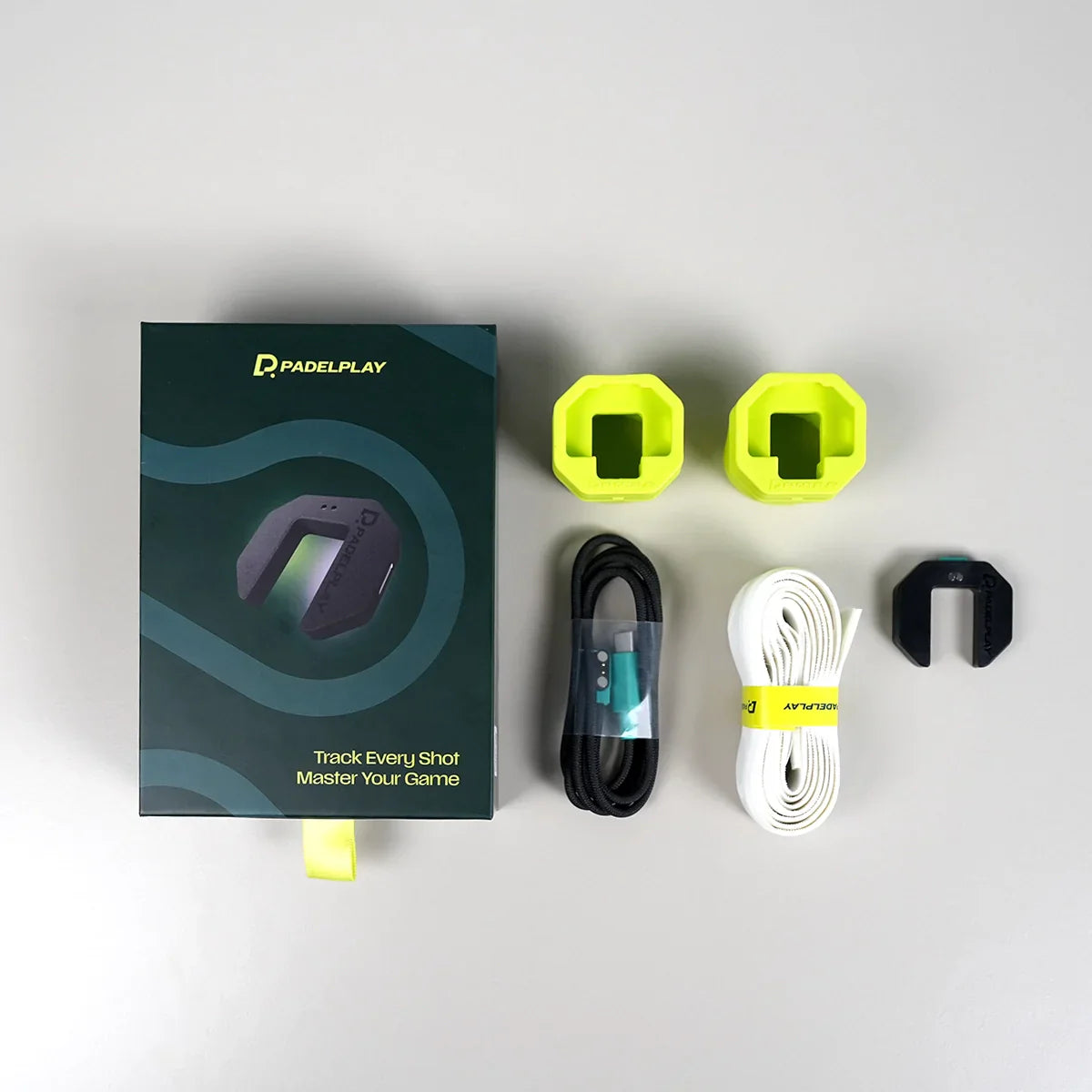 PadelPlay product packaging with accessories on a light gray background
