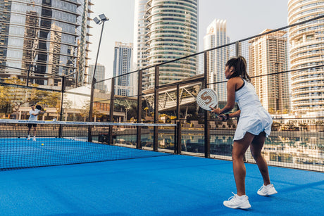 girl playing outdoor padel tennis in dubai