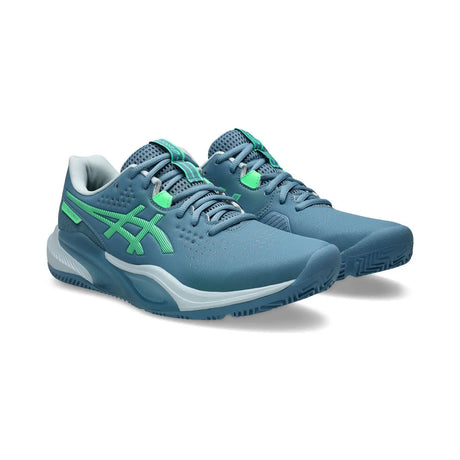 Blue running shoes with green accents on a white background