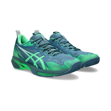 Blue and green running shoes on a white background