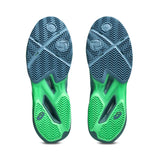 Green and blue athletic shoes with tread pattern on a white background