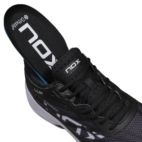 Black athletic shoe with NOX branding on a white background