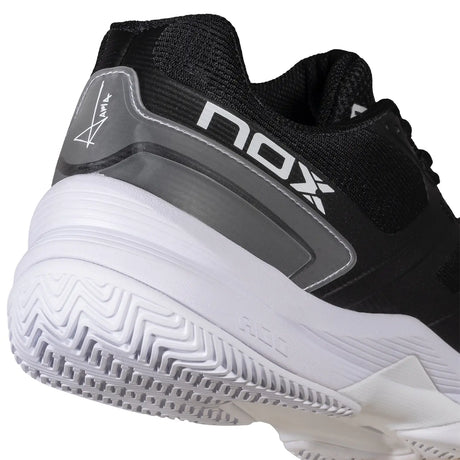 Black and white sports shoe with 'NOX' branding on a white background