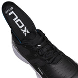 Black athletic shoe with visible brand logo on a white background