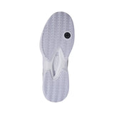Close-up of a white sneaker sole with tread pattern on a white background