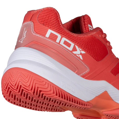 Red sports shoe with white sole on a white background