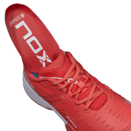 Red athletic shoe with 'On' branding on a white background