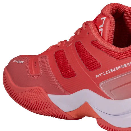 Red athletic shoe with white sole on a white background