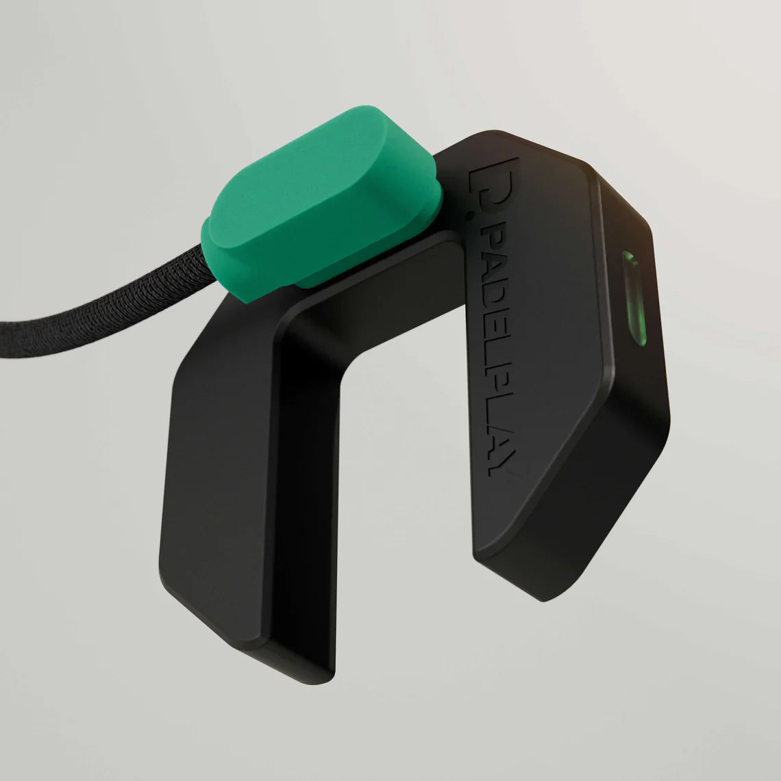 Black and green device with 'PADELPLAY' branding on a light gray background