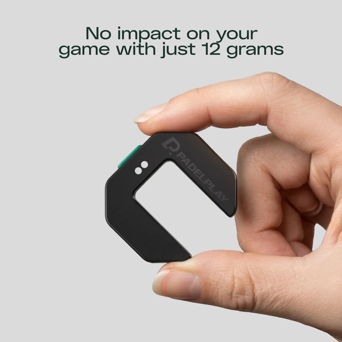 Hand holding a small black device with 'PADELPLAY' branding