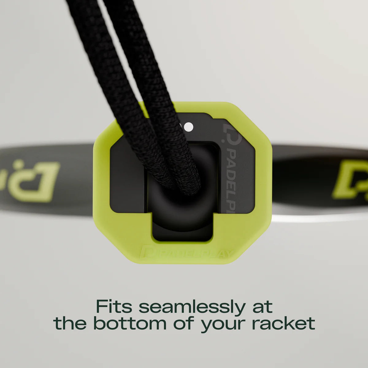 Close-up of a green and black racket grip with text on a gray background