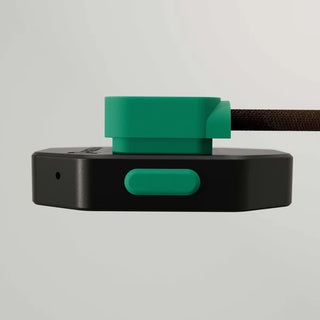 Black and green padelplay AI device with a strap on a light gray background