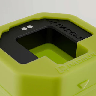 Close-up of a green and black sports equipment piece with 'PADEL' branding.